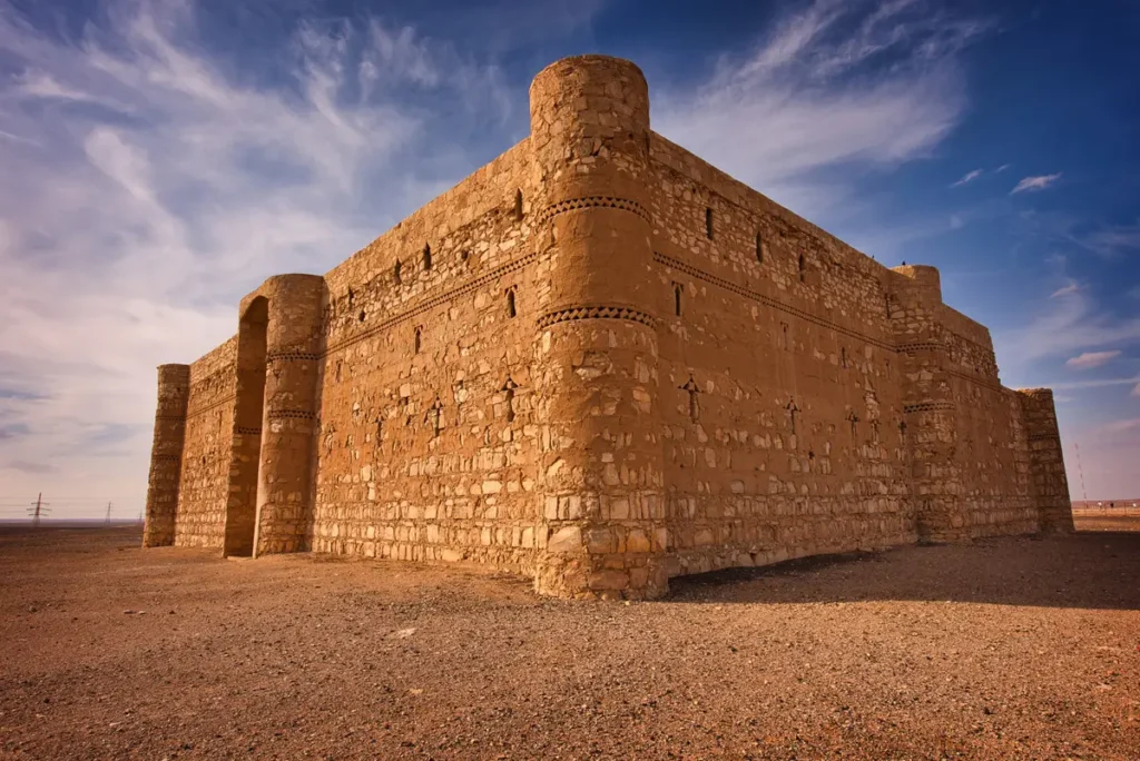 The rounded corner towers and high stone walls of Qasr Kharana, Jordan