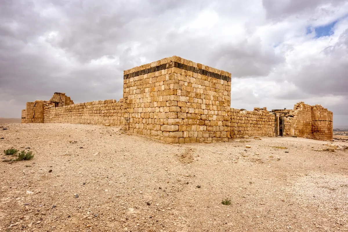The square tower and walls of Qasr Al-Hallabat on its hill, Jordan
