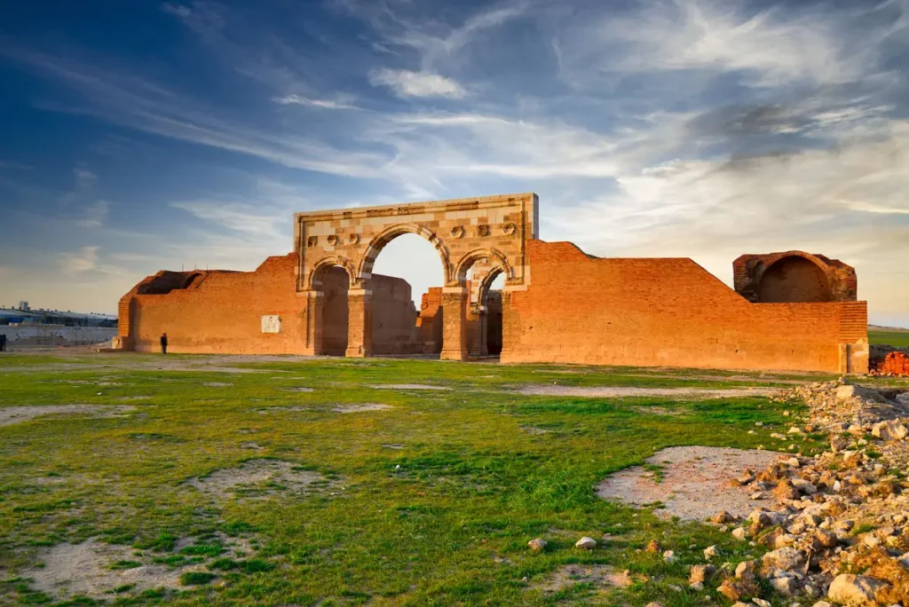 The re-erected triple arch and fired-brick walls of Qasr Al-Mushatta, Jordan