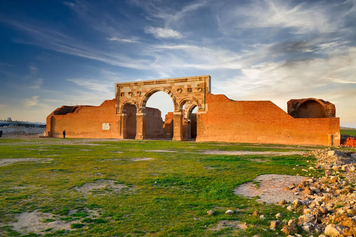The re-erected triple arch and fired-brick walls of Qasr Al-Mushatta, Jordan