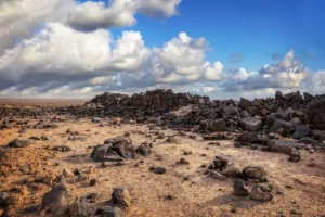 The low mound of the fort under clouds, Qasr Uweinid, Jordan