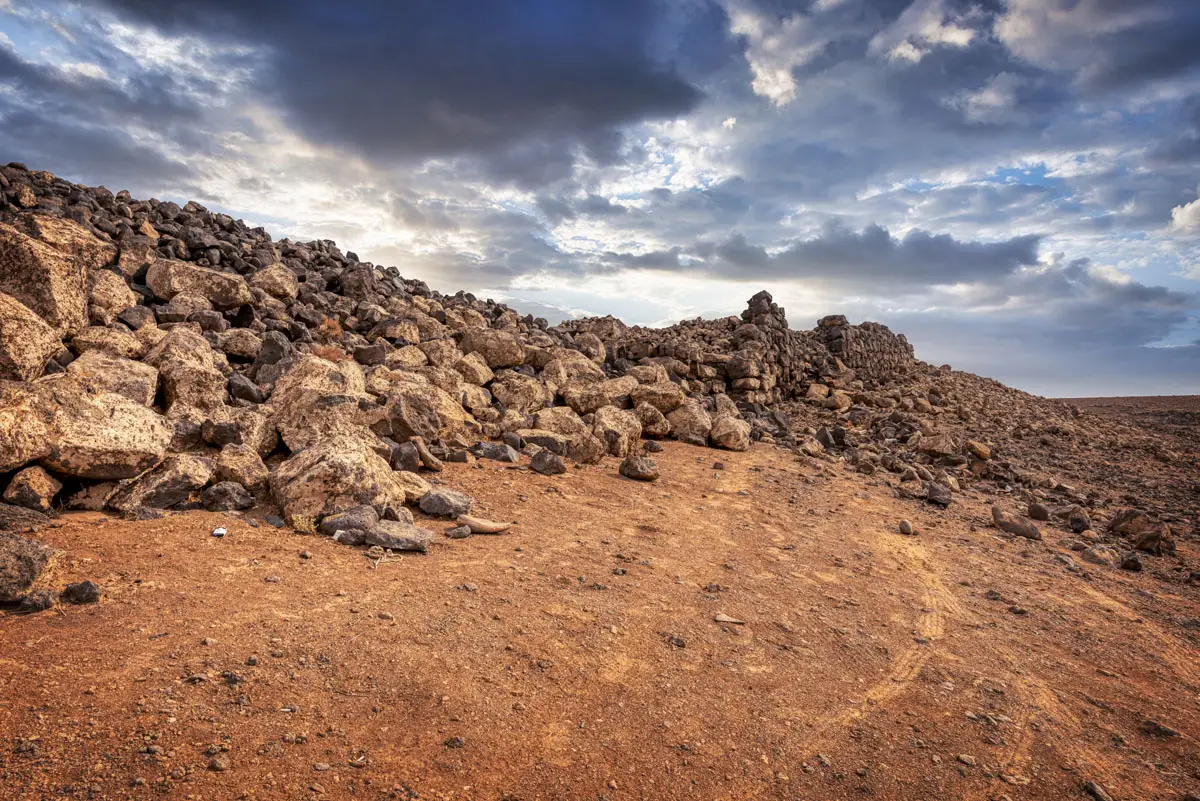 Basalt blocks along a passage through the town wall, Jawa, Jordan