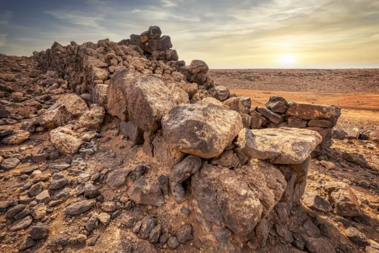 Basalt blocks of a gate in the low sun, Jawa, Jordan