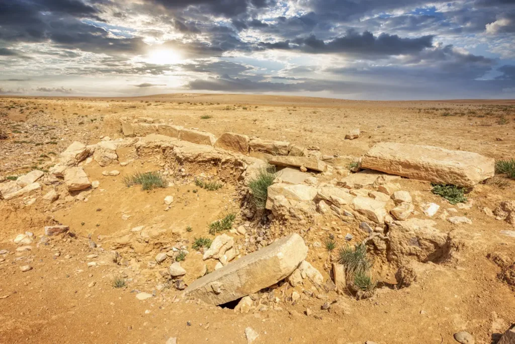 The low walls of the reservoir under a cloudy sky, Qasr Mshash, Jordan